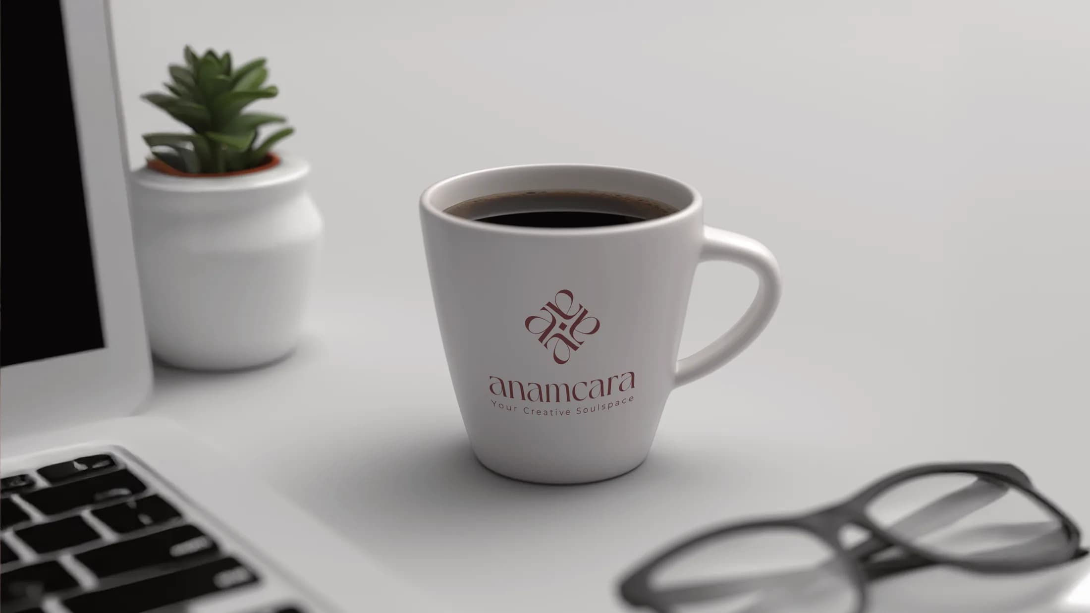 Anamcara branded ceramic cup on a work desk