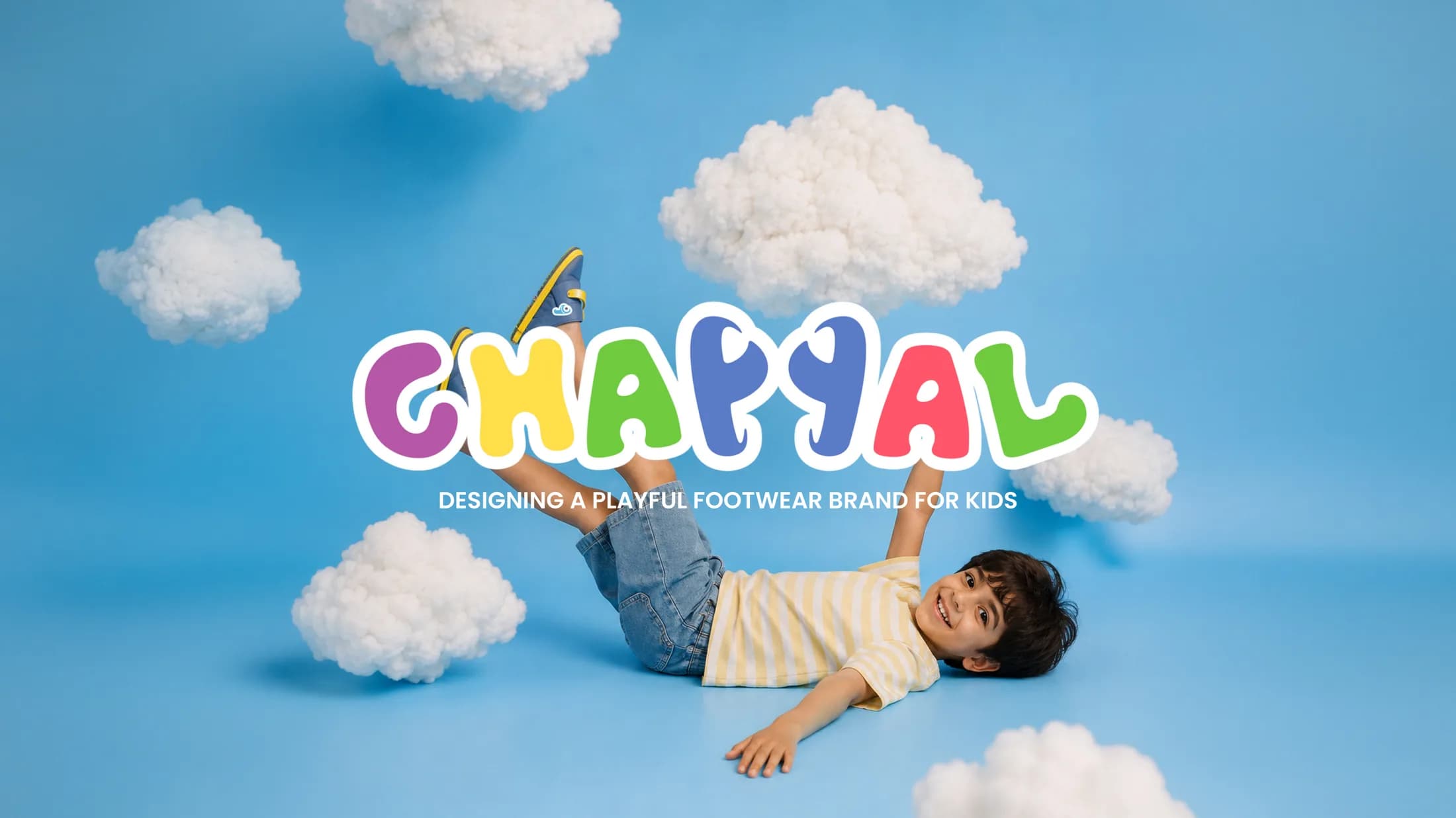 Chappal brand hero — a kid lying on sky-blue ground among clouds under the colorful Chappal logo