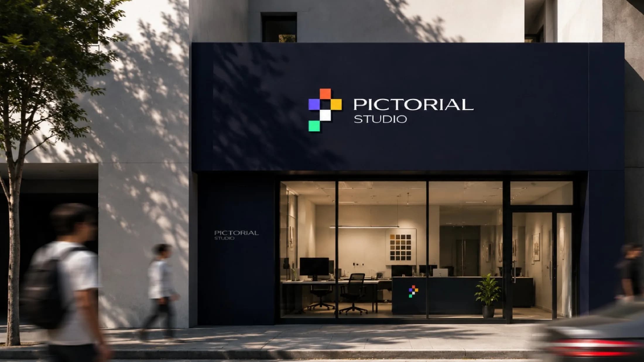 Pictorial Studio storefront at dusk with the pixel-P logo on dark signage