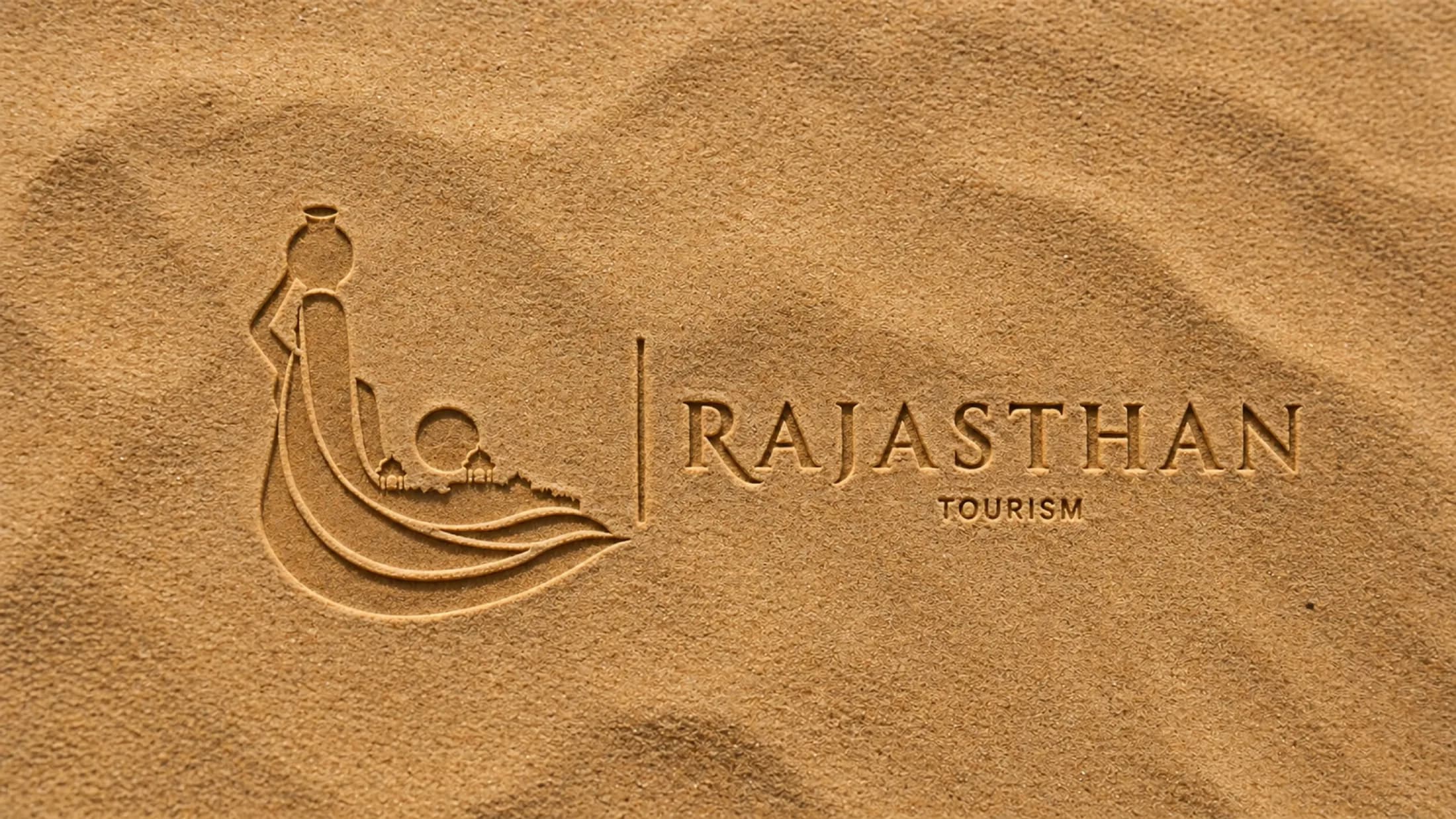 Rajasthan Tourism logo embossed into rippled desert sand